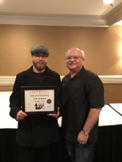 Food Safety 1st, Russell Scott presents Cole Kondra the 13,000th Food Safety 1st certificate.