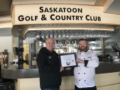 Food Safety 1st, Russell Scott presents Pat Mitchell the 12,000th Food Safety 1st certificate.